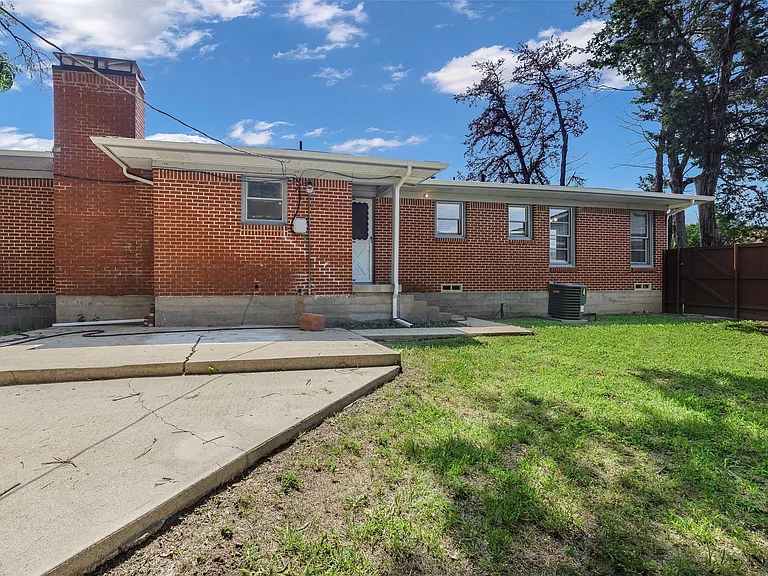 Back of property featuring a yard, central AC, and a patio area