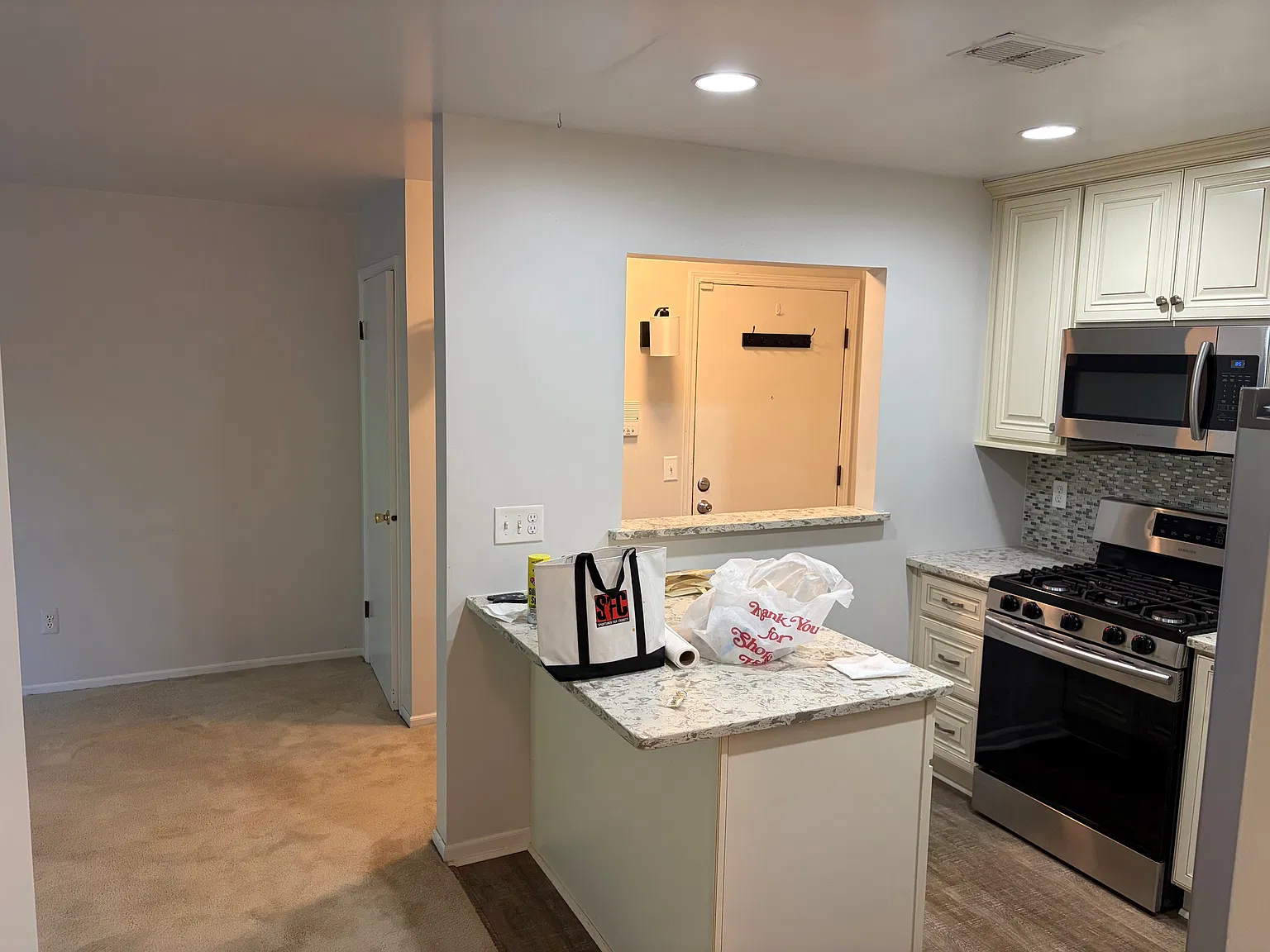 Entry door and view of kitchen
