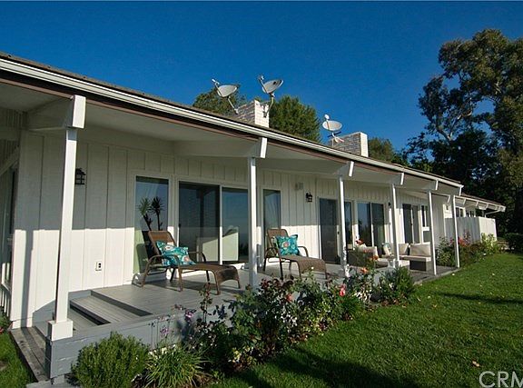Beautiful back porch merges the indoors and outdoors - sliding glass doors in master suite, living room and family room bring in great natural light.