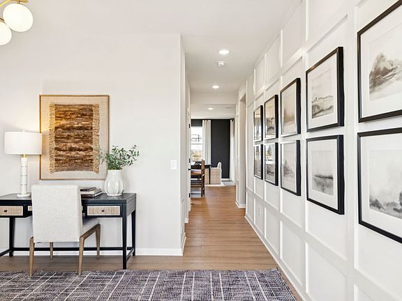 Walk from the main level flex room down the hallway and into the rest of the home