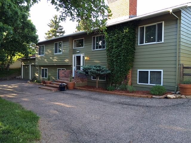 Front of home with wide circular drive.