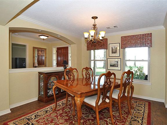 View of dining room and foyer from den.