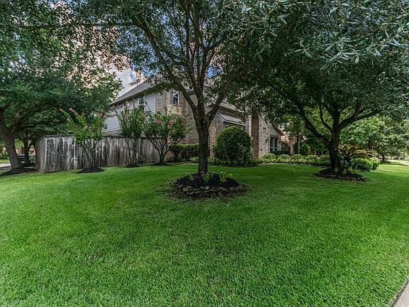 Spacious corner lot surrounded by mature trees and landscaping.