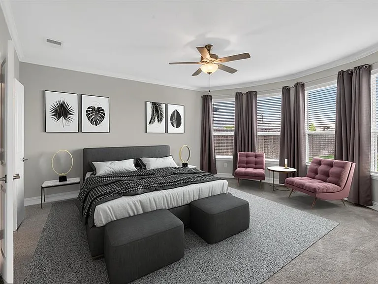 Spacious room featuring a bay window with multiple large panes, crown molding, a ceiling fan, and light gray wall paint