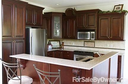 Kitchen
						:
						Kitchen has stainless steel appliances and solid cherry wood cabinets.