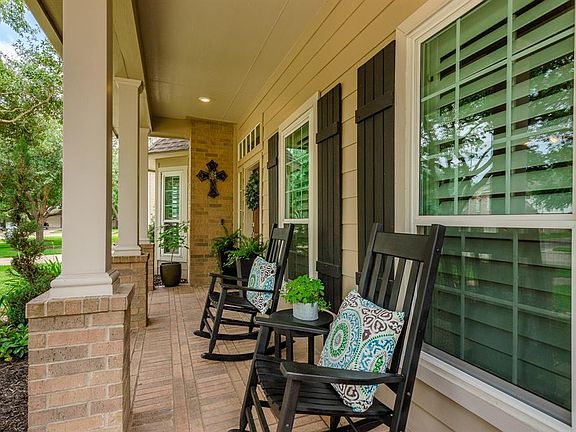 The covered brick front porch is both charming and welcoming.