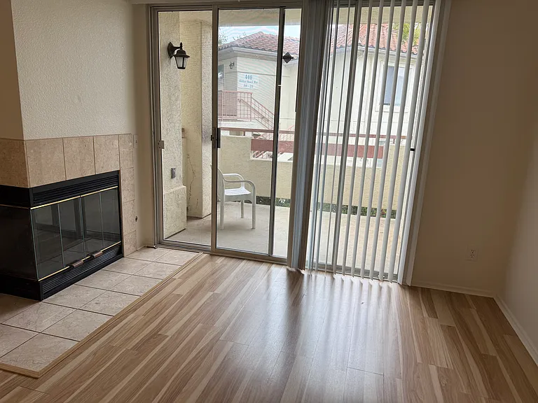 Living room with gas fireplace and private balcony