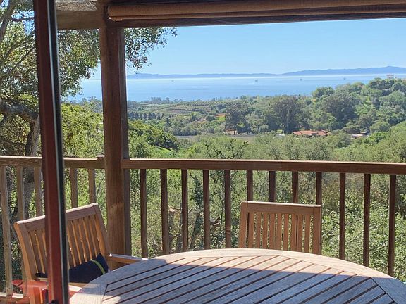 2nd floor deck table and chairs looking out at Channel Islands