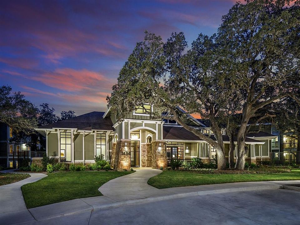 Sunset Leasing office exterior from circle drive with lush landscape