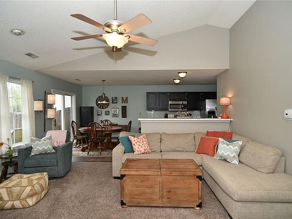 Great room has vaulted ceilings with ceiling fan already in place.