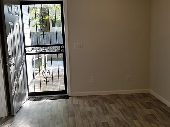 Backdoor coming into large laundry room that has space to make a home office.