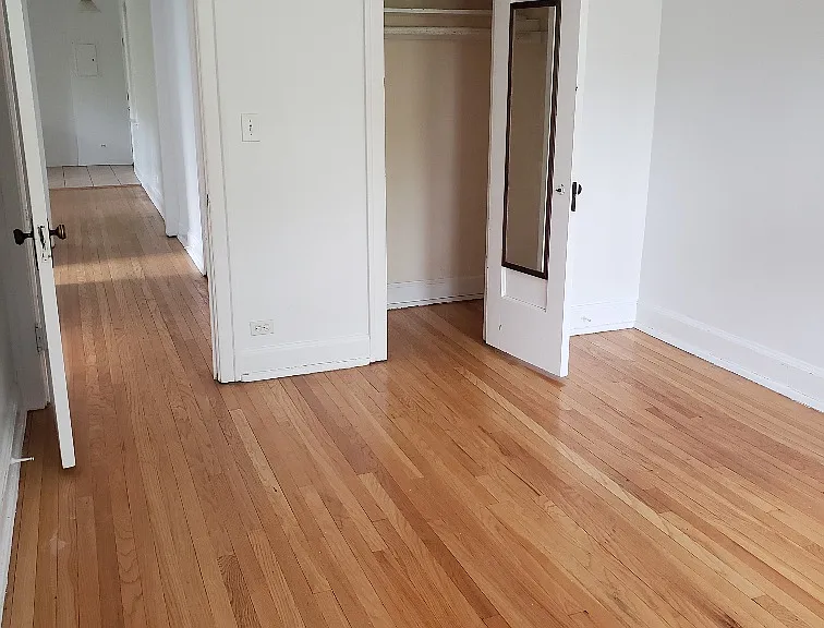 2nd berdoom view showing hardwood floors throughout apartment and professional painting completed Aug 13, 2024 througout
