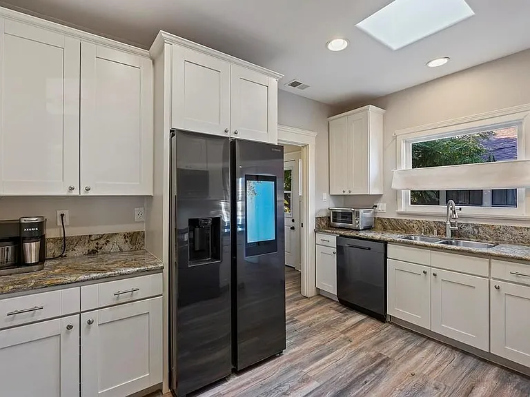 The updated with stainless steel appliances in the kitchen