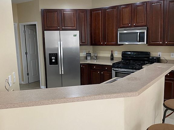 Kitchen with cherry hardwood cabinets