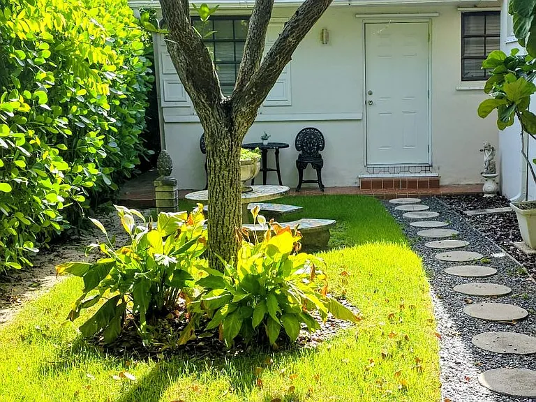 Private pathway to tiny vintage home main entrance