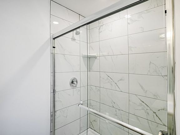 5' long shower with 24" tile & glass door in Primary suite