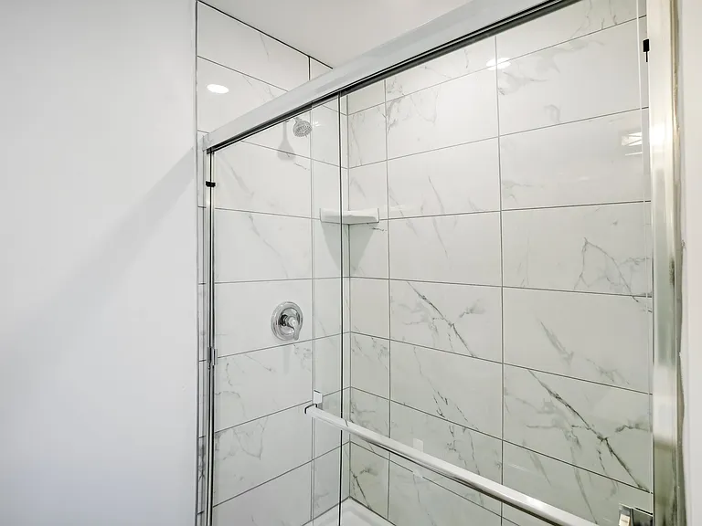 5' long shower with 24" tile & glass door in Primary suite