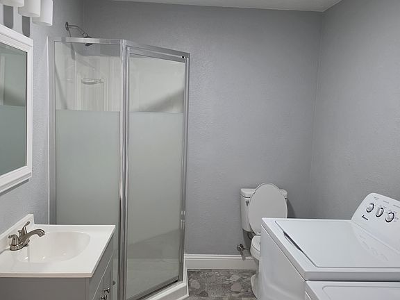 Remodeled bathroom with a new washer and dryer included in the lease