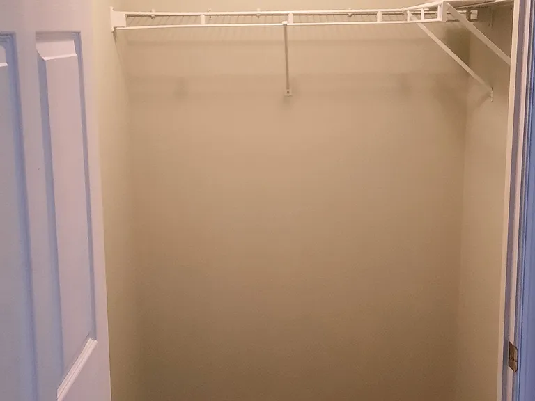 Guest closet with shelving and hanging space as well.
