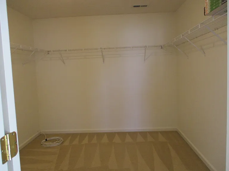Owner's Large Walk In Closet with Emergency Escape Ladder on Shelf