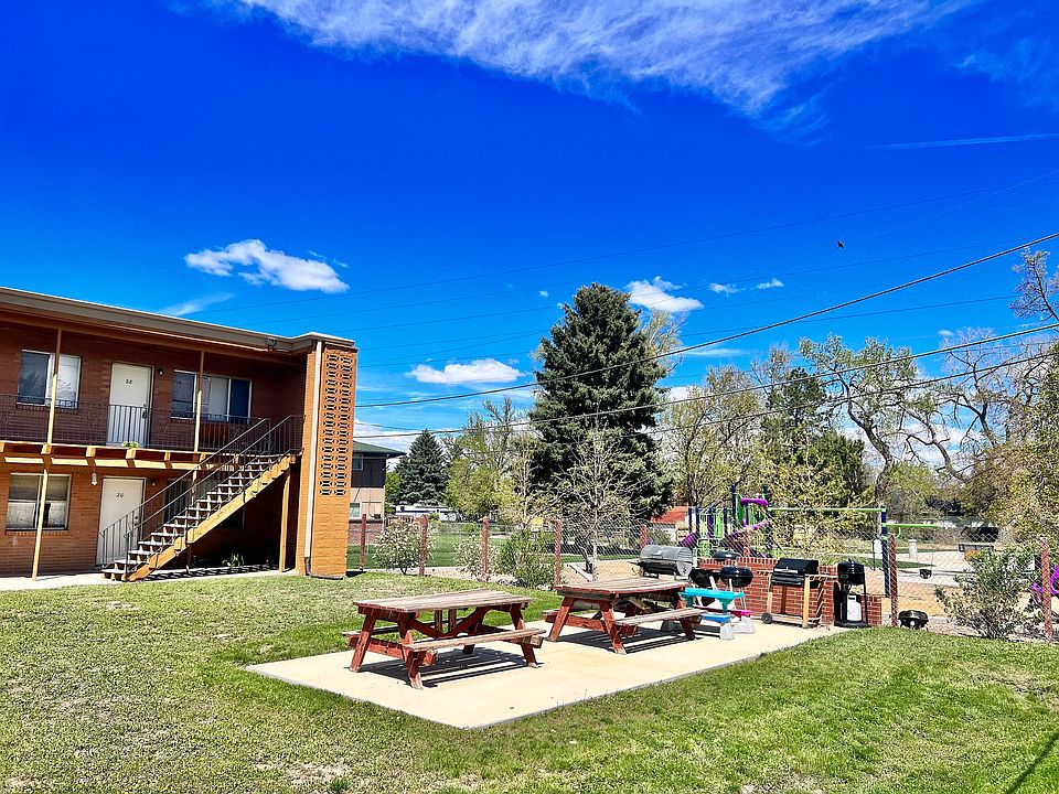 Enjoy outdoor living with ample seating and a fun play area for kids.