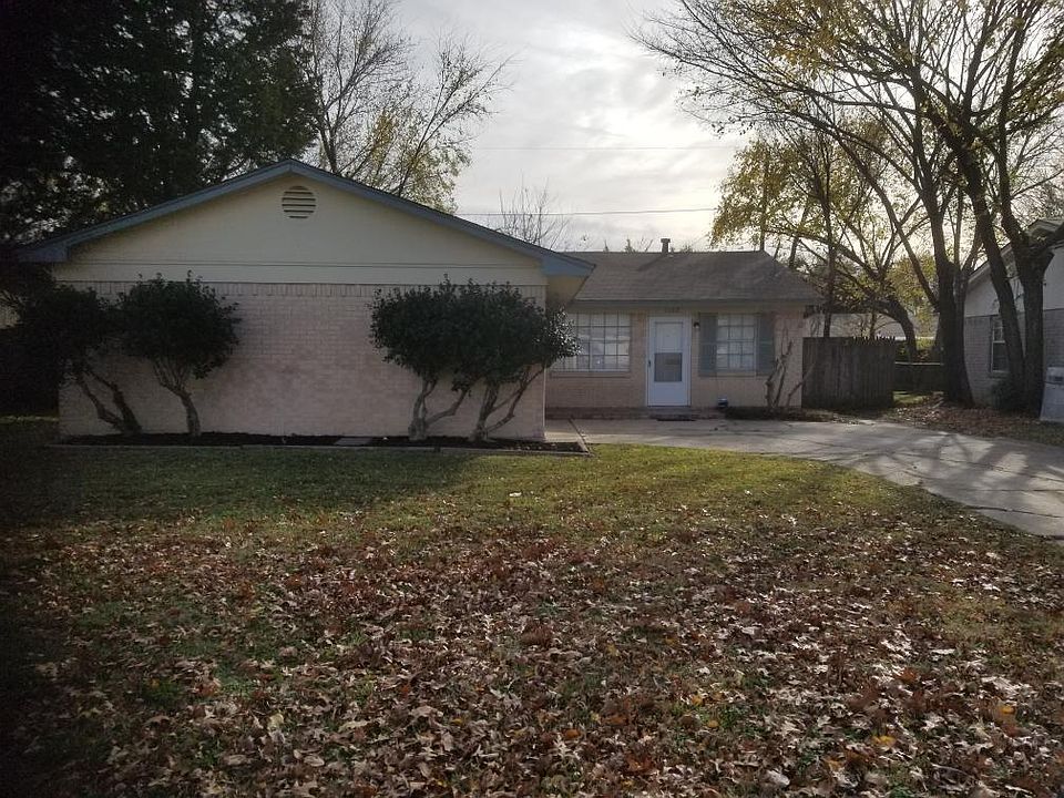front of house from sidewalk, garage, living room window, front door and window in kitchen.