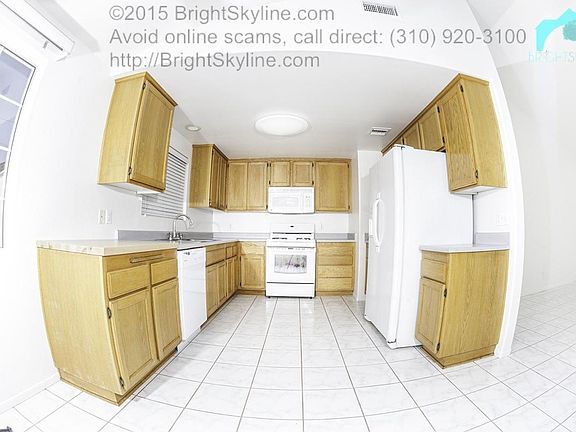 Kitchen with refrigerator, dishwasher and stove.