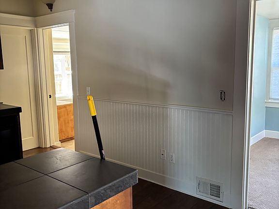 Bedroom with fire exit on left / room for office or third bedroom on right , kitchen in foreground .