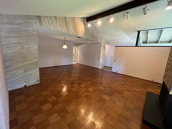 Living room looking at door ways to the kitchen and entry way.