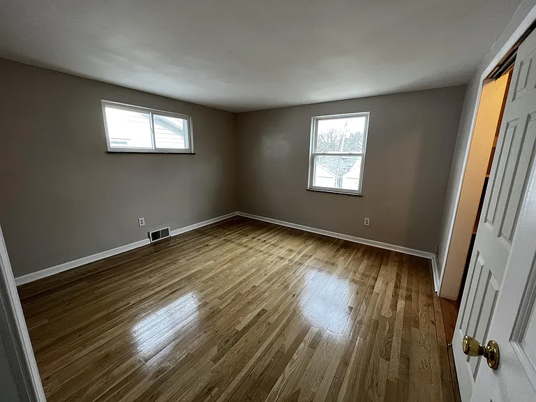 Back bedroom with polished hardwood floors