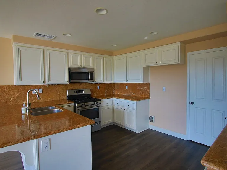 Kitchen with granite countertops, stainless steel appliances