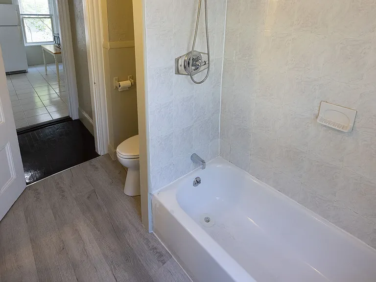 Full bathroom featuring tub/shower combination and updated finishes