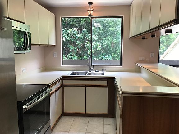 Kitchen window looks out to back hillside