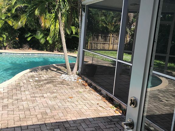 Screened in Lanai adjacent to pool, sliding doors accessible from house.