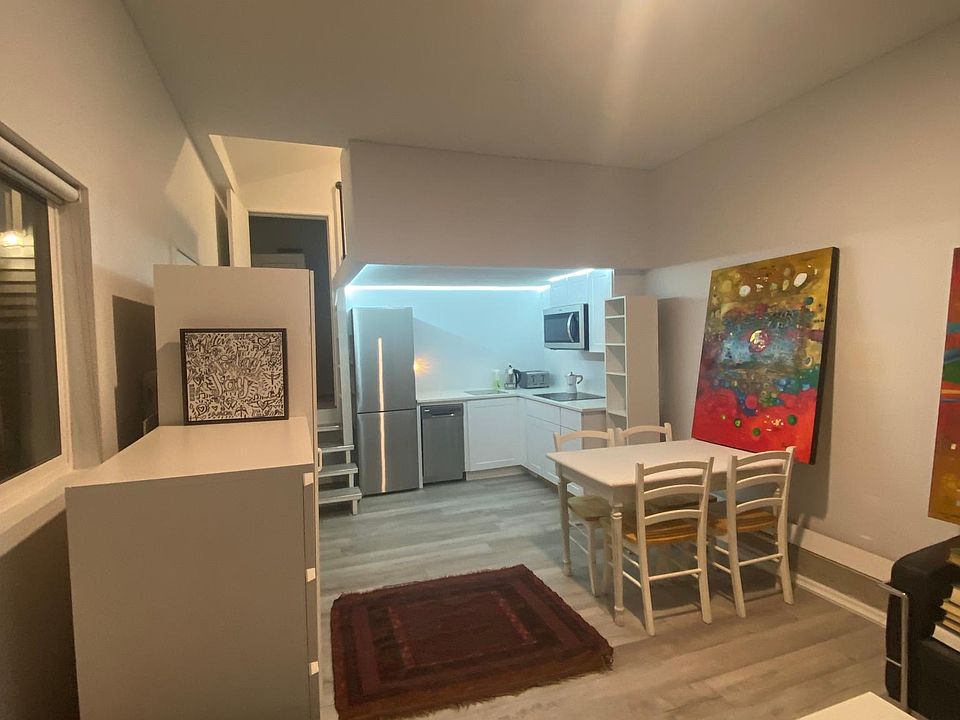 Living space with kitchen - stairs to bathroom on left