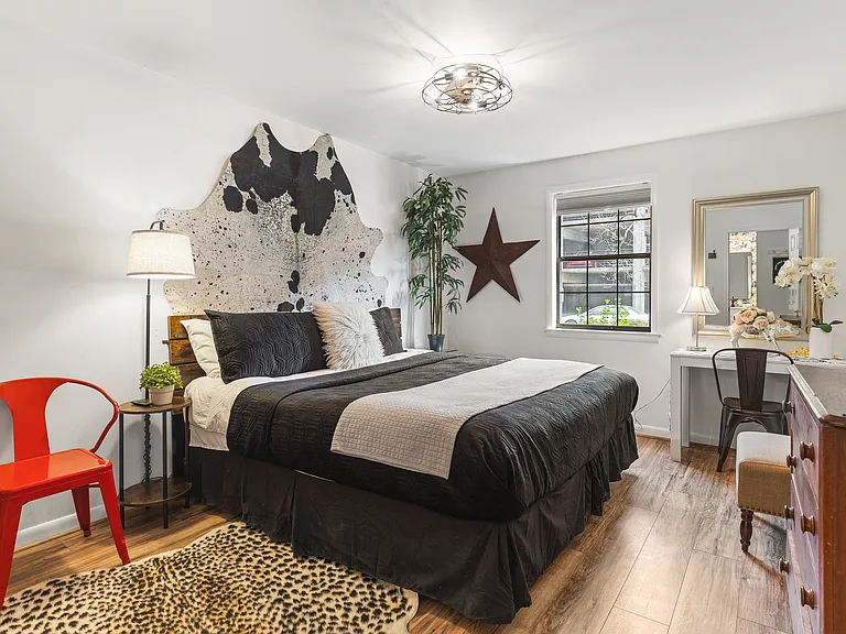 Comfortable King bed in the bedroom. Includes a smart TV, desk to get ready at, dresser and a closet to store your items in.