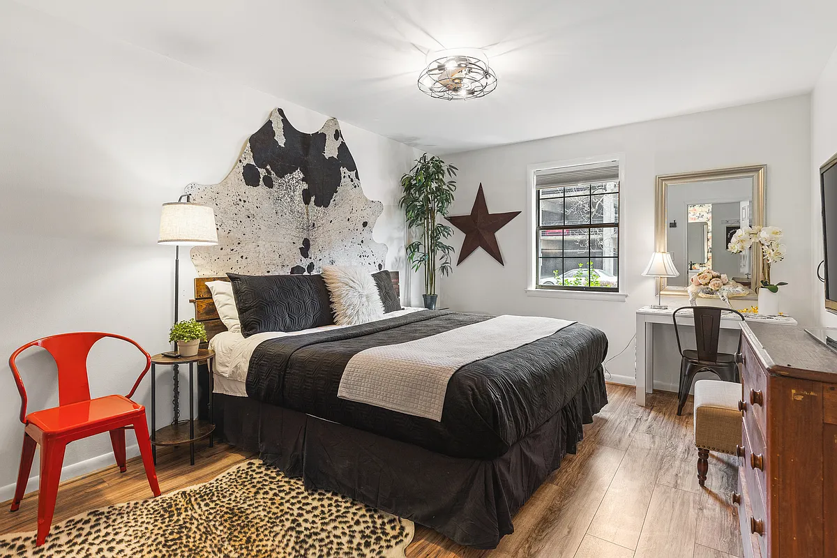 Comfortable King bed in the bedroom. Includes a smart TV, desk to get ready at, dresser and a closet to store your items in. - 907 18th Ave S #104
