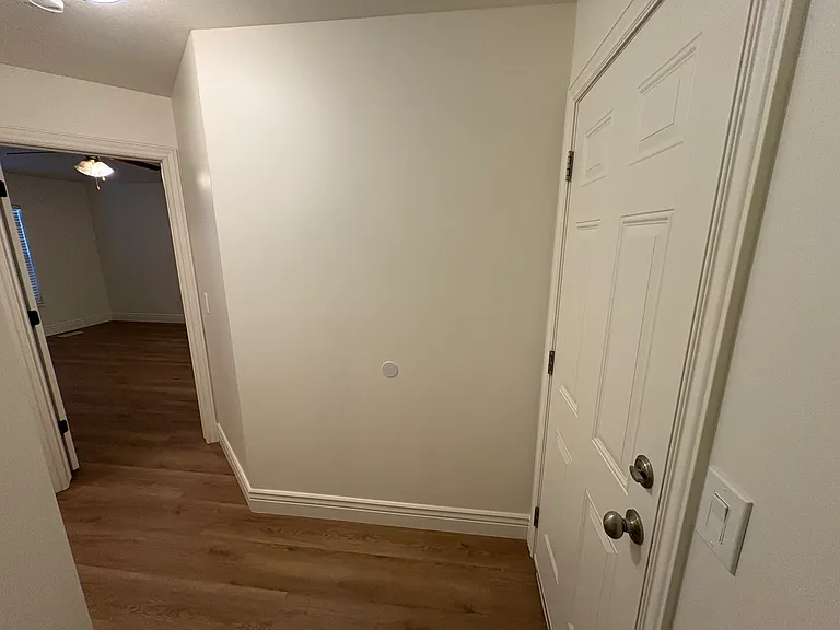 Garage door and hallway to master bedroom