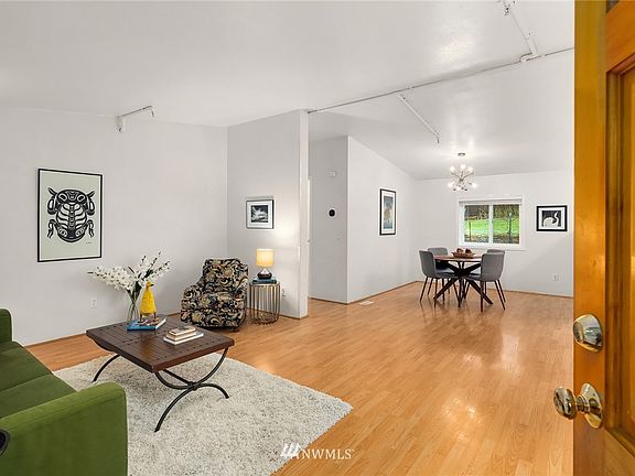 Enter into the great room with vaulted ceilings and plenty of light. 