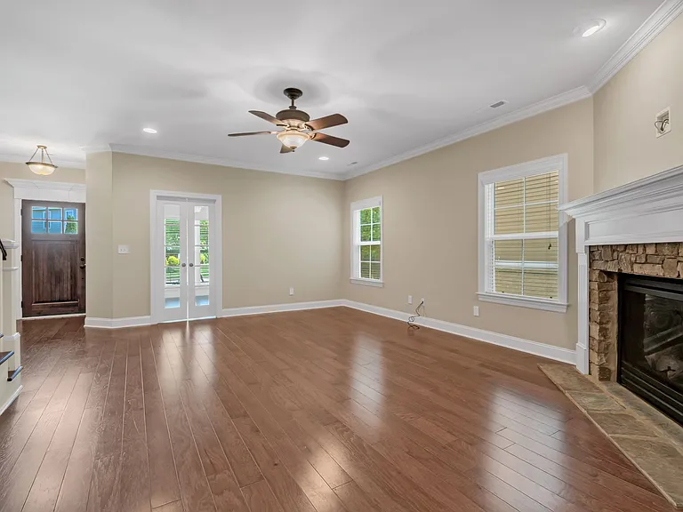Open living room includes ceiling fan