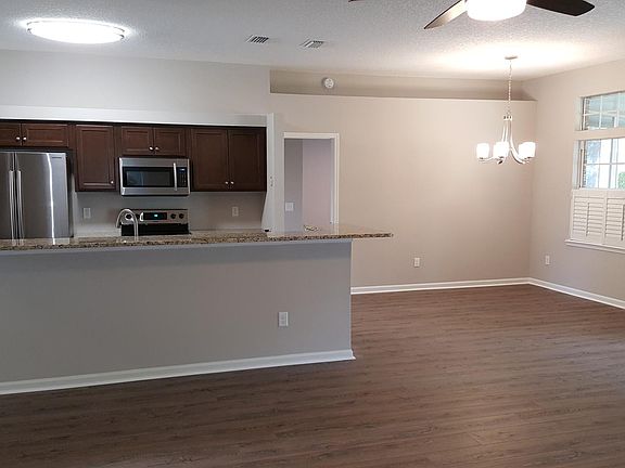 view of kitchen and eat-in area from den