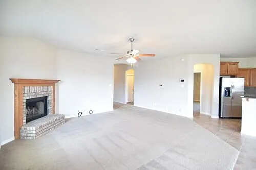 Large living room with brick fireplace & ceiling fan/light & soft clean carpet. - 2902 Coal Oil Dr