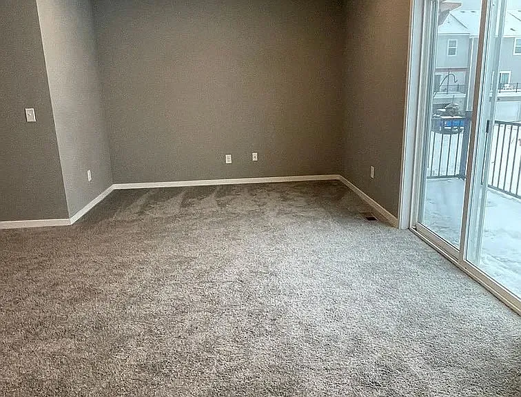 Step into the spacious living area at LS Capital Group, where modern design meets comfort. Natural light pours in, highlighting the plush carpet and inviting ambiance. Envision your new lifestyleAaaschedule a tour today!