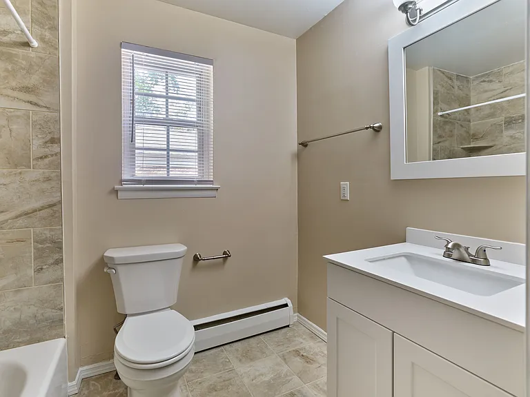 Freshly updated bathroom with clean tile finishes and modern vanity at Maple Terrace Apartments in Maple Shade, NJ