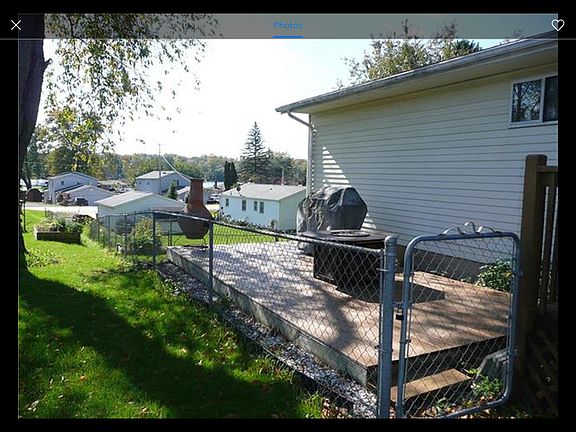Side view of fenced in yard and deck