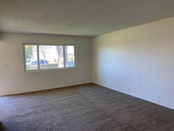 Living room. Brand new blind is bing installed on the 96" long window.