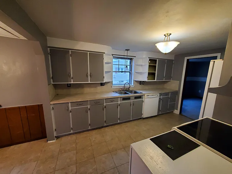 Kitchen with stove, dishwasher and refrigerator.