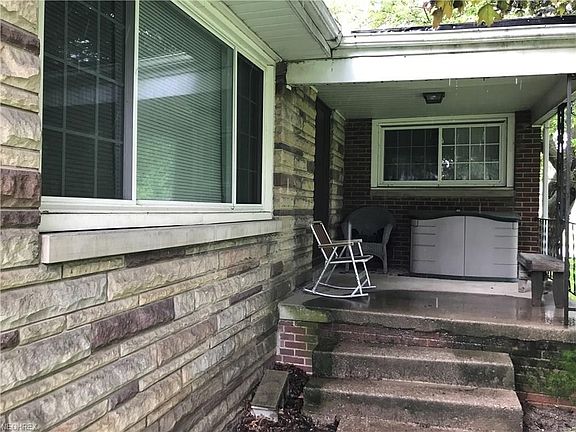 Home is ALL Red Brick with Premistone on part of the front.  Covered porch nice for rocking!