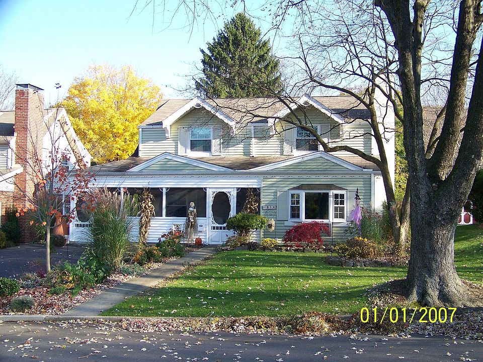Beautiful landscaping red sugar maple aside of driveway
