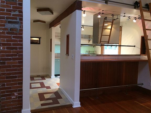 hallway between front door, kitchen and living room with built in bar